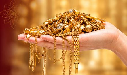 Hand holding gold jewellery